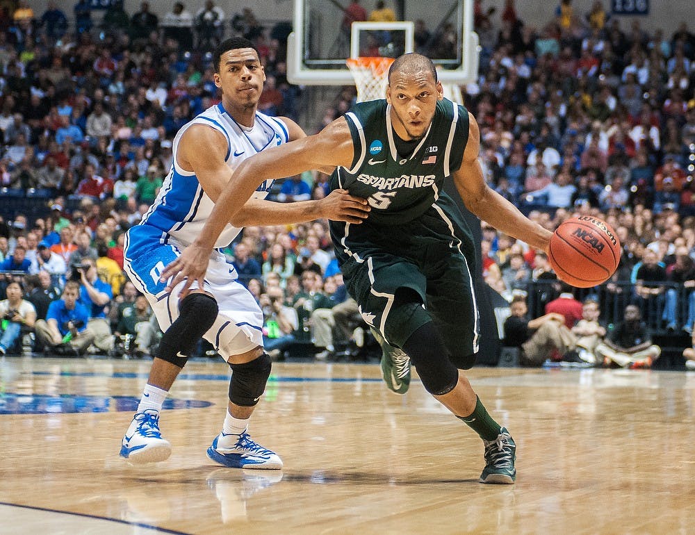 	<p>Junior center Adreian Payne drives the ball toward the basket Friday, March. 29, 2013, at Lucas Oil Stadium in Indianapolis, Ind. The Duke Blue Devils defeated the Spartans, 71-61, in the Sweet Sixteen of the <span class="caps">NCAA</span> Tournament and now advance to the Elite Eight. Adam Toolin/The State News</p>