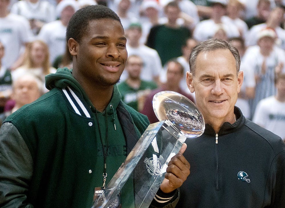 	<p>Michigan State football coach, Mark Dantonio,right, smiles with junior running back Le&#8217;Veon Bell after Bell receives the College Football Performance Awards Elite Running Back Trophy on Saturday, Dec. 8, 2012 at halftime of the basketball game against Loyola-Chicago at the  Breslin Center. Katie Stiefel/State News</p>