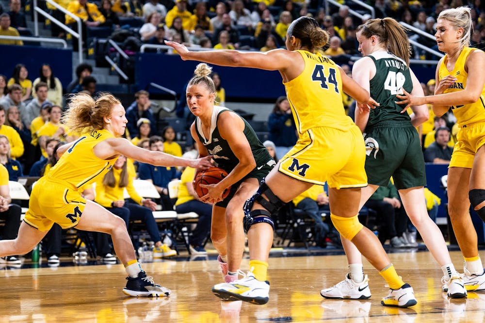 Michigan State sophomore guard No. 4 Theryn Hallock drives the net at the Crisler center in Ann Arbor, Feb. 18, 2024. Michigan State secured a season sweep of the rival Wolverines, breaking a two-game losing streak in the process.
