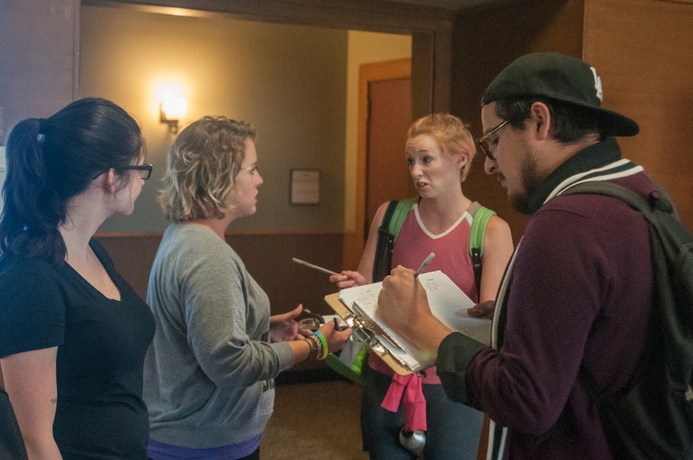 From left, Women's studies and interdisciplinary studies senior Hannah Miller, zoology senior Alyse Maksimoski, and doctoral student Elise Dixon talk about the petition to take back the women's study lounge while Everardo Cuevas signs the petituin on August 31, 2016 in the Union.