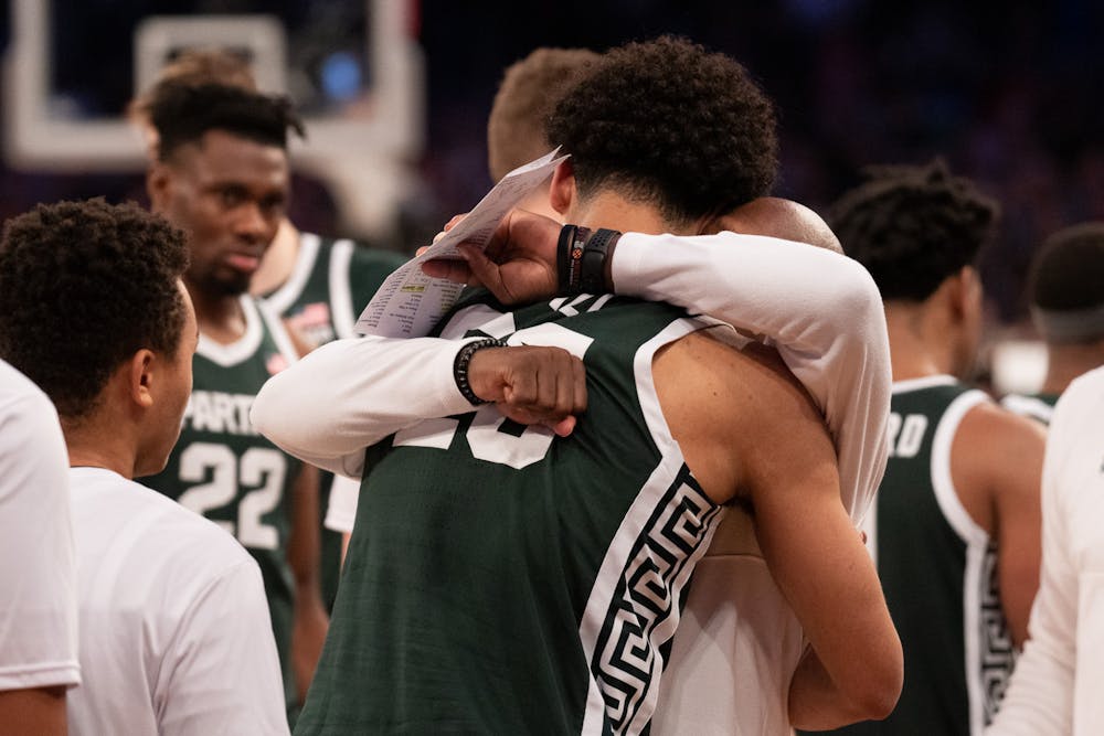 Senior forward Malik Hall embraces Assistant Coach Mark Montgomery after the Sweet Sixteen matchup against Kentucky State University at Madison Square Garden on March 23, 2023. The Spartans fell to the Wildcats with a score of 98-93. 