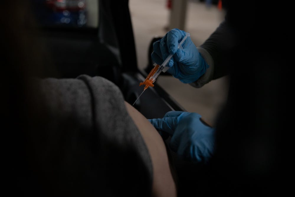 <p>A student receiving their vaccine at the Michigan State University, or MSU Pavilion on April 15, 2021.</p>