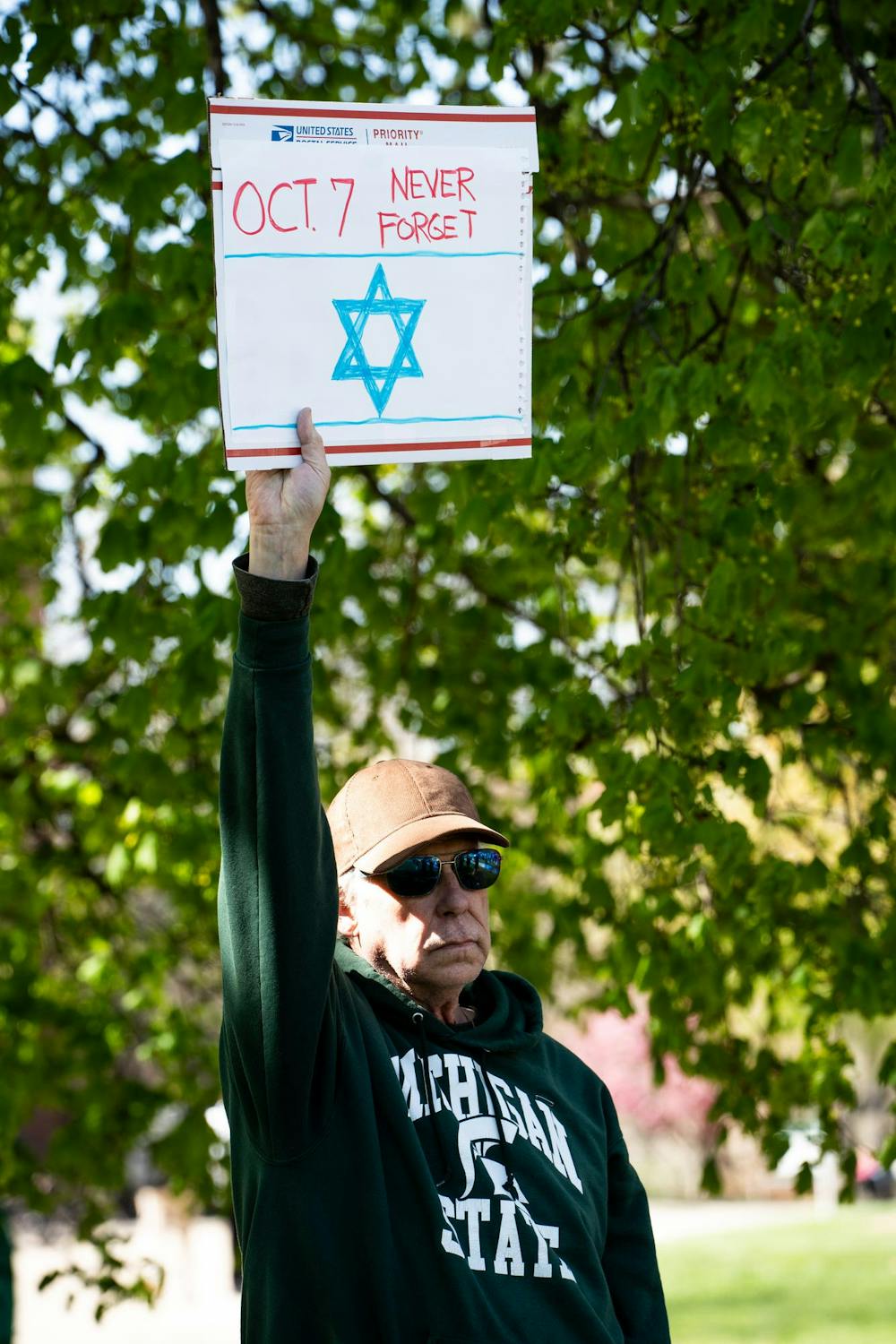 Michigan State University community member holds a pro-Israel sign near the Gaza solidarity encampment in People’s Park on MSU’s campus on April 25, 2024.