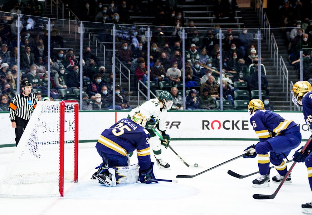 <p>Michigan State junior Erik Middendorf looking to make a play for the goal or pass it out as he is surrounded by Notre Dame players on Feb. 19, 2022. Spartans lost 4-2 against Notre Dame.</p>