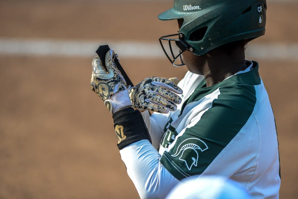 <p>A Spartan softball player adjusts her gloves during the game against Oakland on April,3, 2019 at Secchia Stadium. The Spartans beat the Golden Grizzlies, 11-3.   </p>