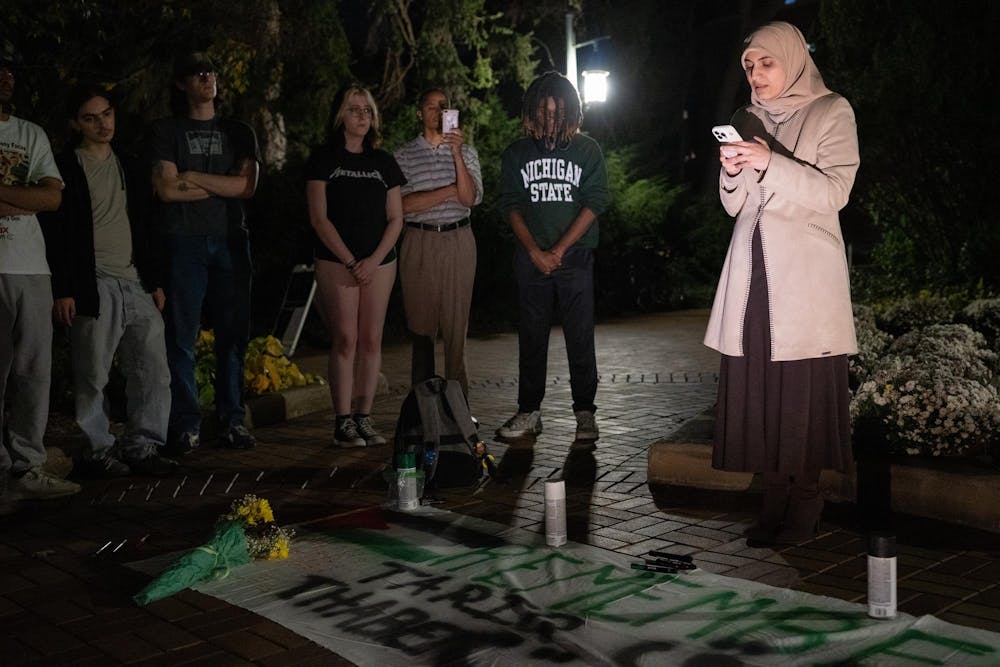 <p>Suporters listen as human biology junior Aesha Zakaria speaks at an anniversary memorial for Michigan State Humphrey fellow and Israeli bombing victim Tariq Thabet on Oct. 30, 2024. Zakaria's family was in contact with Thabet shortly before his death last year.</p>