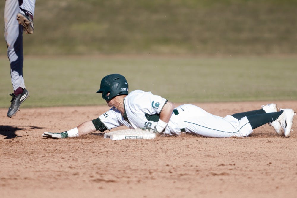 Junior infielder Royce Ando (13) safely lands on to the second base during the game against Central Michigan on March 21, 2017 at McLane Stadium at Kobs Field. The Spartans defeated the Chippewas, 11-2.