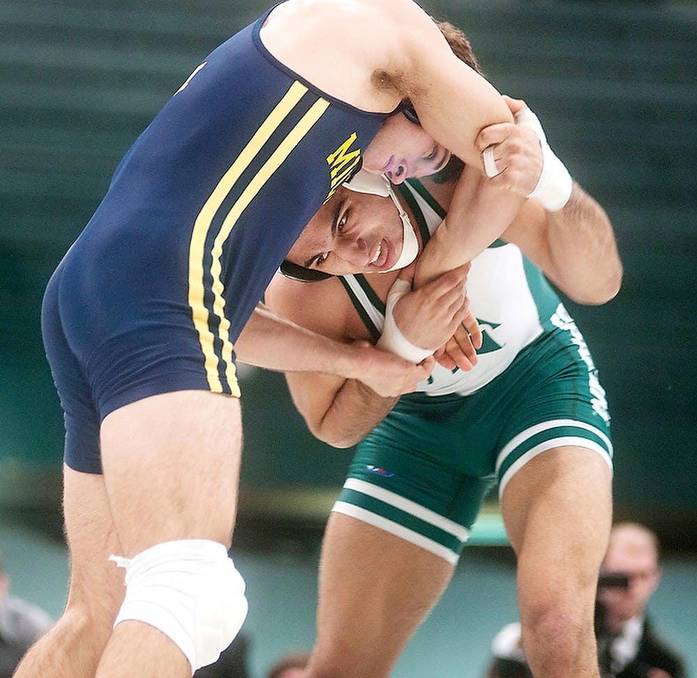 	<p>Sophomore 184-pounder John Rizqallah wrestles with Michigan 184-pounder Chris Heald during a match on Sunday, Feb. 10, 2013, at Jenison Field House. <span class="caps">MSU</span> lost the meet 24-15. Danyelle Morrow/The State News</p>