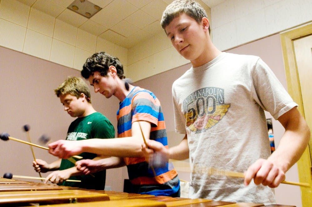 Music education freshman Matt Nabozny, left, freshman music student Reilly Spitzfaden, center, and Alexy Levigne, also a freshman education student, right, practice the marimba for their studio recital Monday at the music building. The trio have been practicing six hours a week for their performance this upcoming Wednesday where they will preform in a low-stress environment in front of their professors and peers. Jaclyn McNeal/The State News