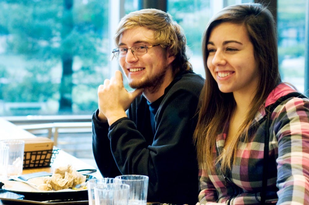 Kinesiology senior Brittany Hardecki and Criminal Justice freshman Gage Grindler enjoy dinner at the grand opening of the Southpointe Cafeteria at Case Hall Sunday night. Southpointe offers a variety of cuisine made with ingredients made in Michigan.  Samantha Radecki/The State News