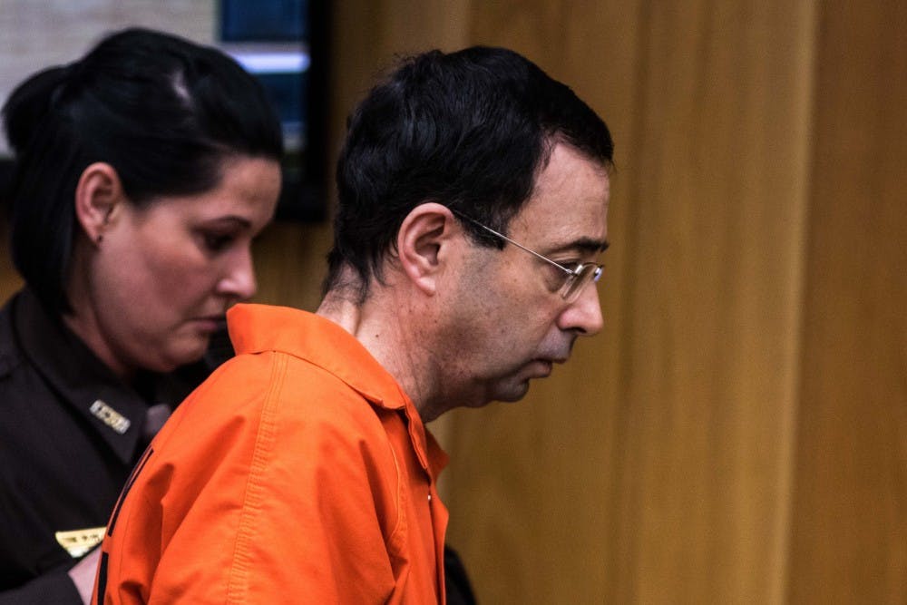 Larry Nassar is escorted out of the courtroom during the first day of sentencing for Larry Nassar on Jan. 31, 2018, in the Eaton County courtroom. Nassar faces three counts of criminal sexual conduct in Eaton County.