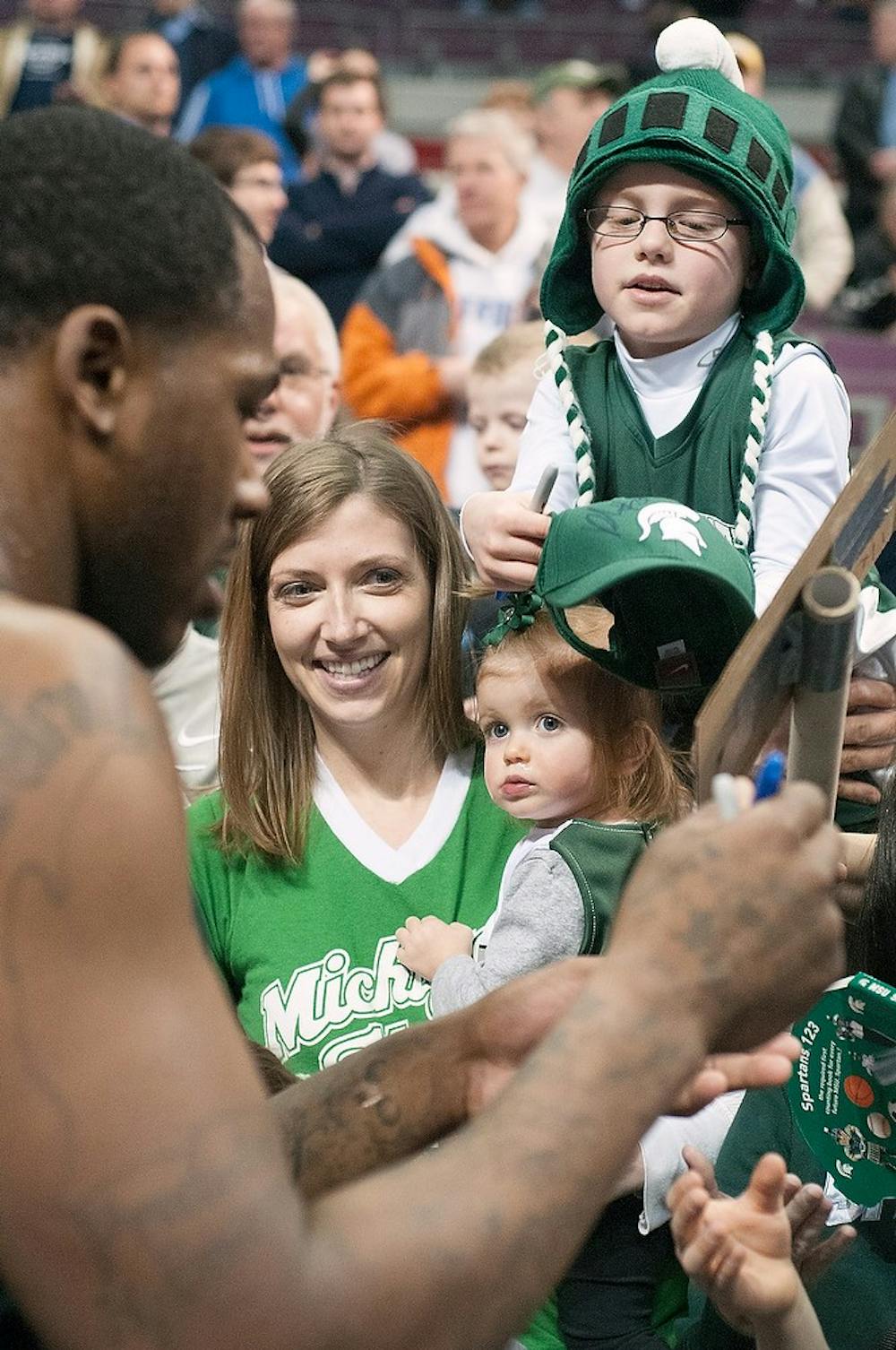 	<p>Senior center Derrick Nix signs items for fans March 20, 2013, at the Palace of Auburn Hills after practice. Nix signed hats, basketballs and other <span class="caps">NCAA</span> memorabilia. Julia Nagy/The State News</p>