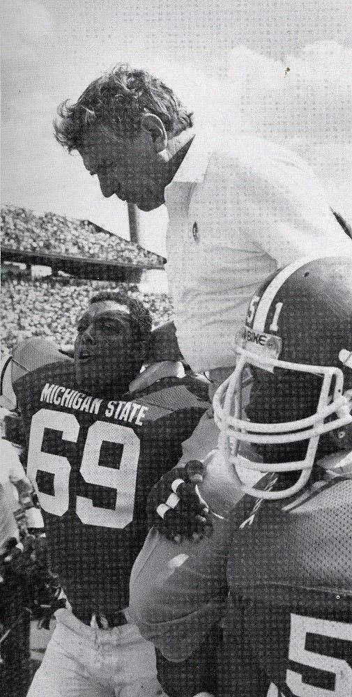	<p>Perles is carried off the field by Allen Moore and Anthony Bell in 1983. Photo courtesy of <span class="caps">MSU</span> Archives </p>