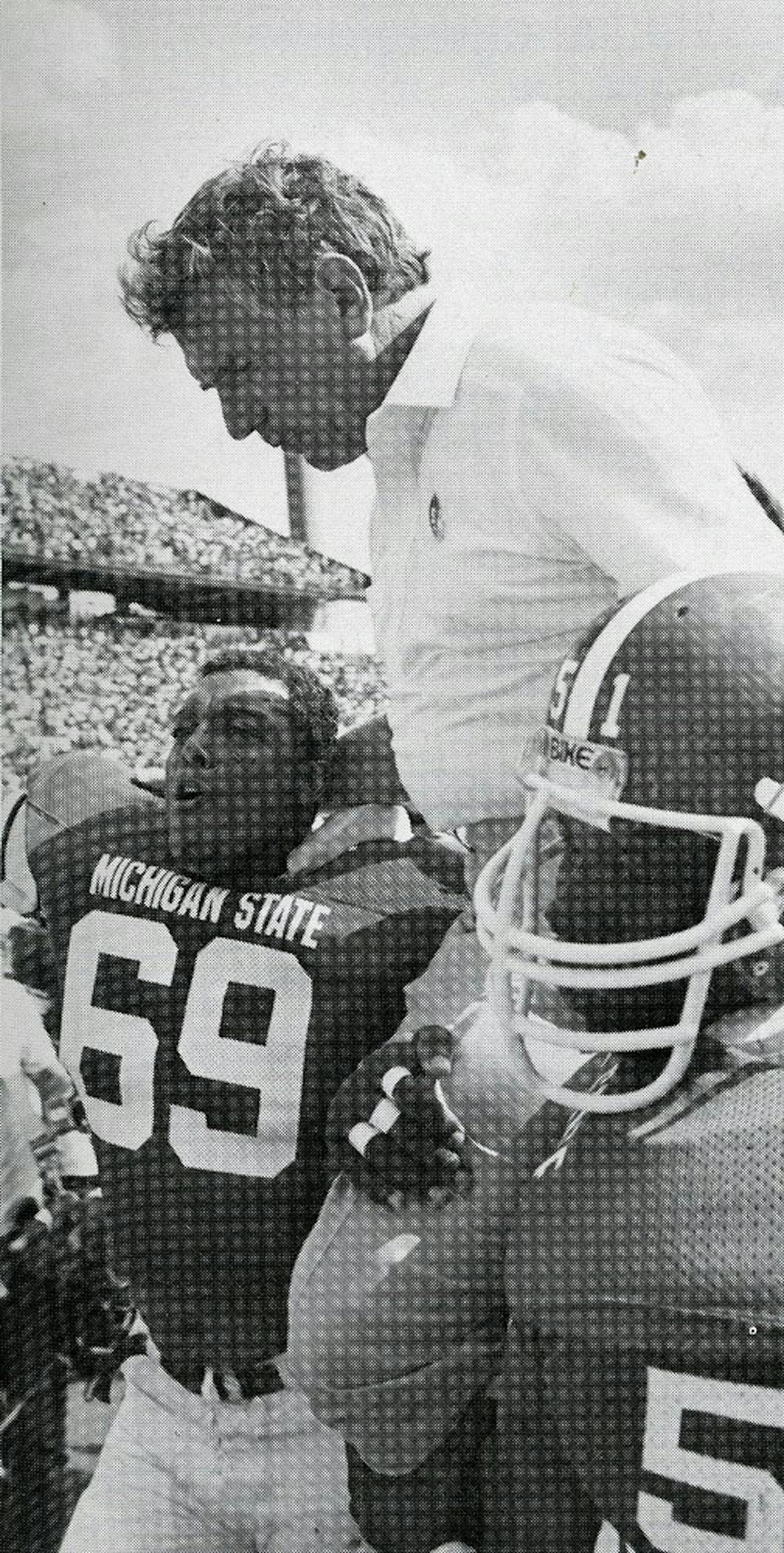 	<p>Perles is carried off the field by Allen Moore and Anthony Bell in 1983. Photo courtesy of <span class="caps">MSU</span> Archives </p>