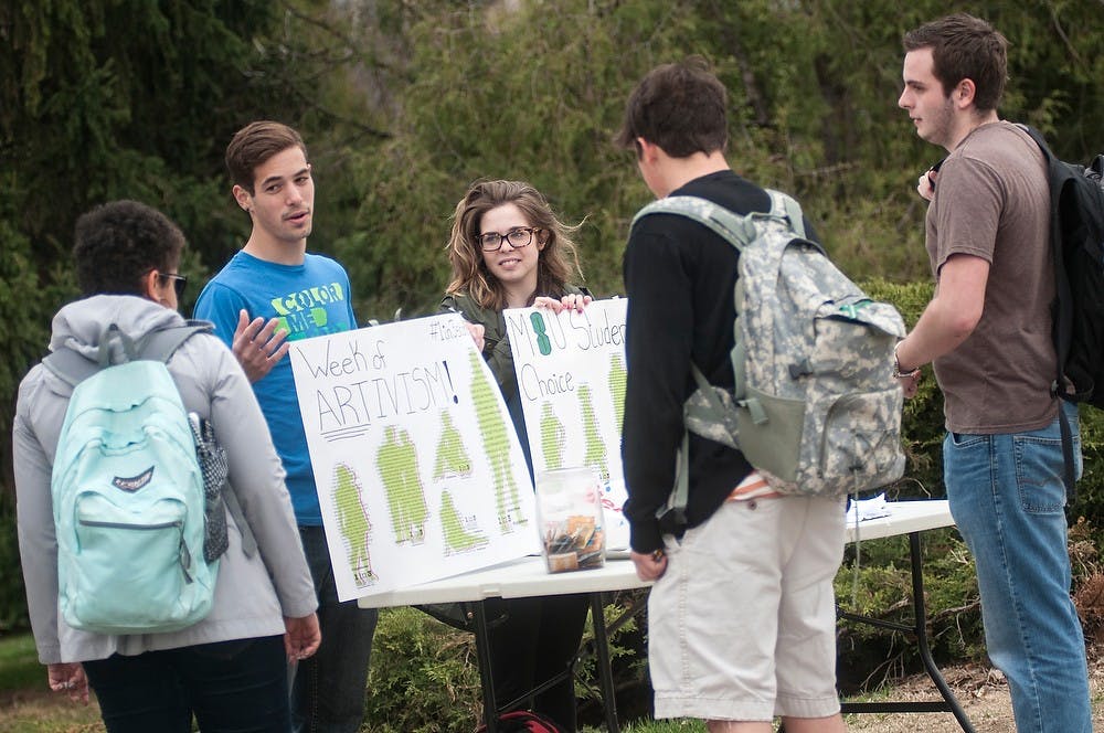 <p>Prenursing sophomore Alicia Geniac and zoology junior Darren Incorvaia talk to students about MSU Students for Choice April 16, 2015, in front of the Rock on Farm Lane. Students for Choice is part of the 1 in 3 Campaign, which works to reduce the stigma around abortion.  Allyson Telgenhof/The State News.</p>