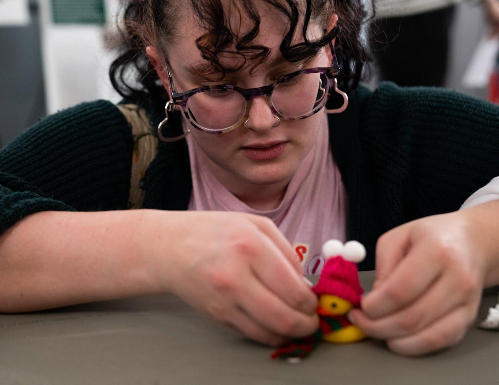 Michigan State political science senior Isabelle Freund decorates a rubber duck at the student union during the Alcohol and Other Drugs Program's Farewell to the Flock event on Dec. 2, 2024.