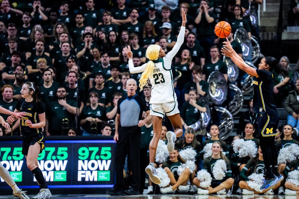 Michigan State Spartans guard Jalyn Brown (23) defends Michigan Wolverines guard Mila Holloway (3) during the women’s rivalry matchup at the Breslin Student Events Center in East Lansing, Mich., on Sunday, Feb. 1, 2026.