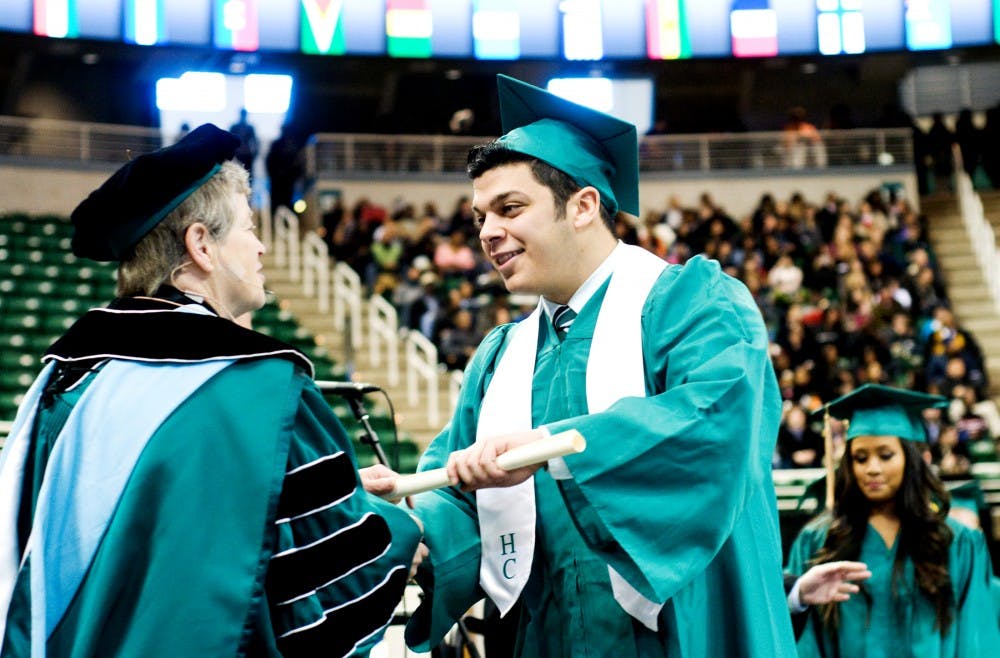 <p>Accounting student Ogeen Kada receives his bachelor&#x27;s degree from then-MSU President Lou Anna K. Simon at the Breslin Center during a commencement ceremony in 2011. Justin Wan/The State News</p>