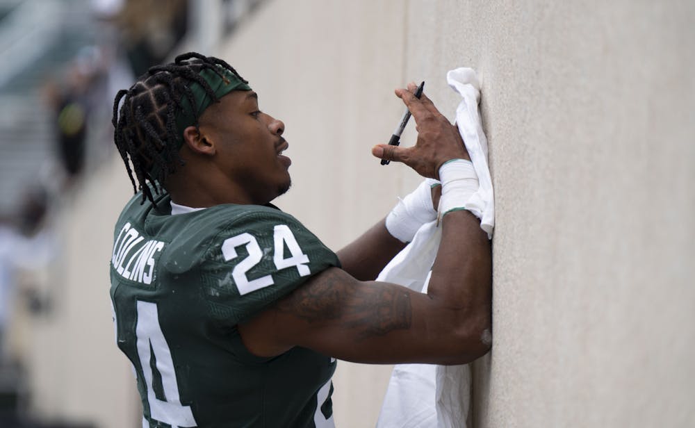 Michigan State Football returned to Spartan Stadium for the spring game on Saturday, April 16. Senior running back Elijah Collins signed t-shirts for fans after the scrimmage. - April 16, 2022.