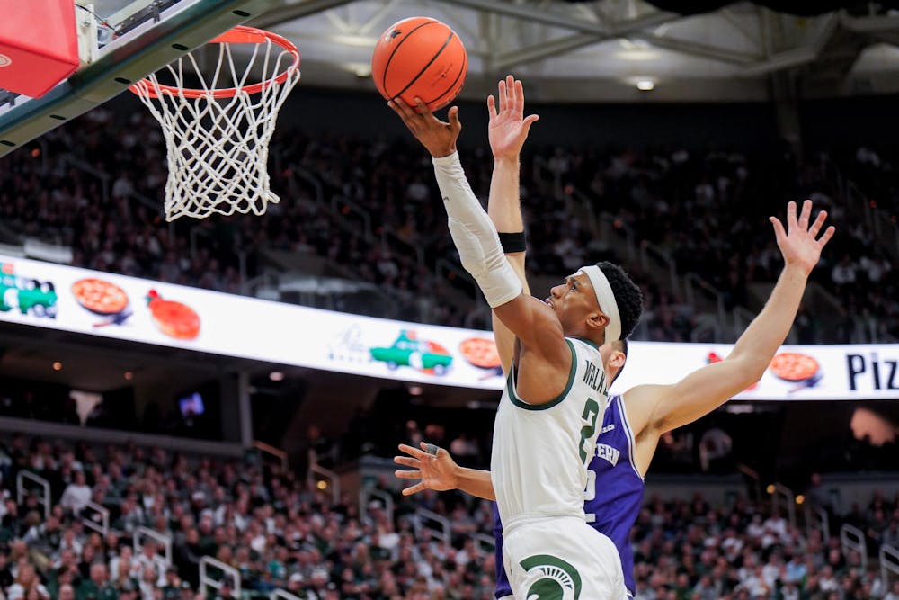 Graduate student Tyson Walker (2) lobs up a ball in the second half of a match against Northwestern University at the Breslin Center on March 6, 2024. The Spartans defeated the Wildcats with a score of 53-49. 
