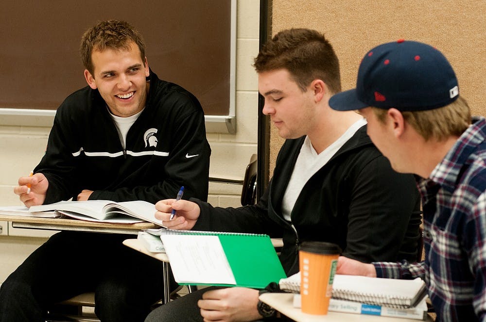 <p>From left applied engineering sciences senior Luke Voelker, finance junior Alex Allen and applied engineering sciences senior Ryan Bertrand work in groups at the beginning of COM 360 on Oct. 6, 2014, at the Communications Arts and Sciences Building. Voelker asked to be in the class because of his interest in technical sales. Aerika Williams/The State News</p>