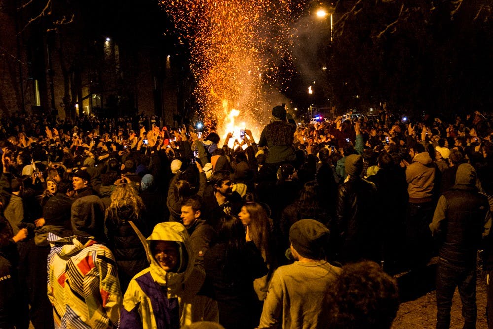 	<p>A crowd feeds a fire on Waters Edge Dr. on Dec. 8, 2013, after <span class="caps">MSU</span>&#8217;s Big Ten Championship game. There were multiple reports of fires throughout East Lansing after the game.</p>