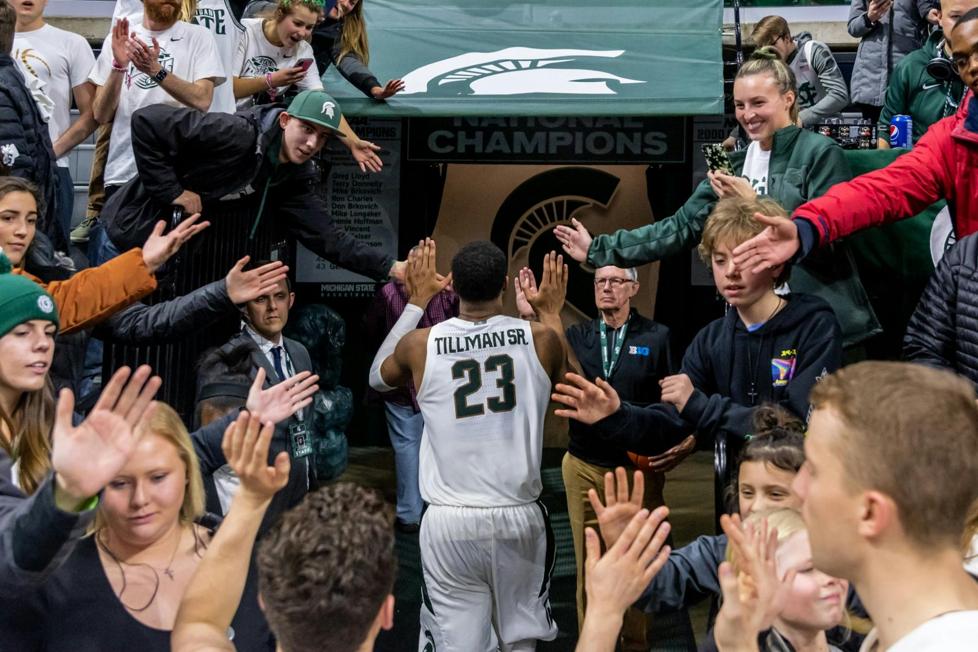 <p>Then-junior forward Xavier Tillman Sr. high-fives fans after a win over Iowa. The Spartans defeated the Hawkeyes, 78-70, at the Breslin Student Events Center on Feb. 25, 2020. </p>