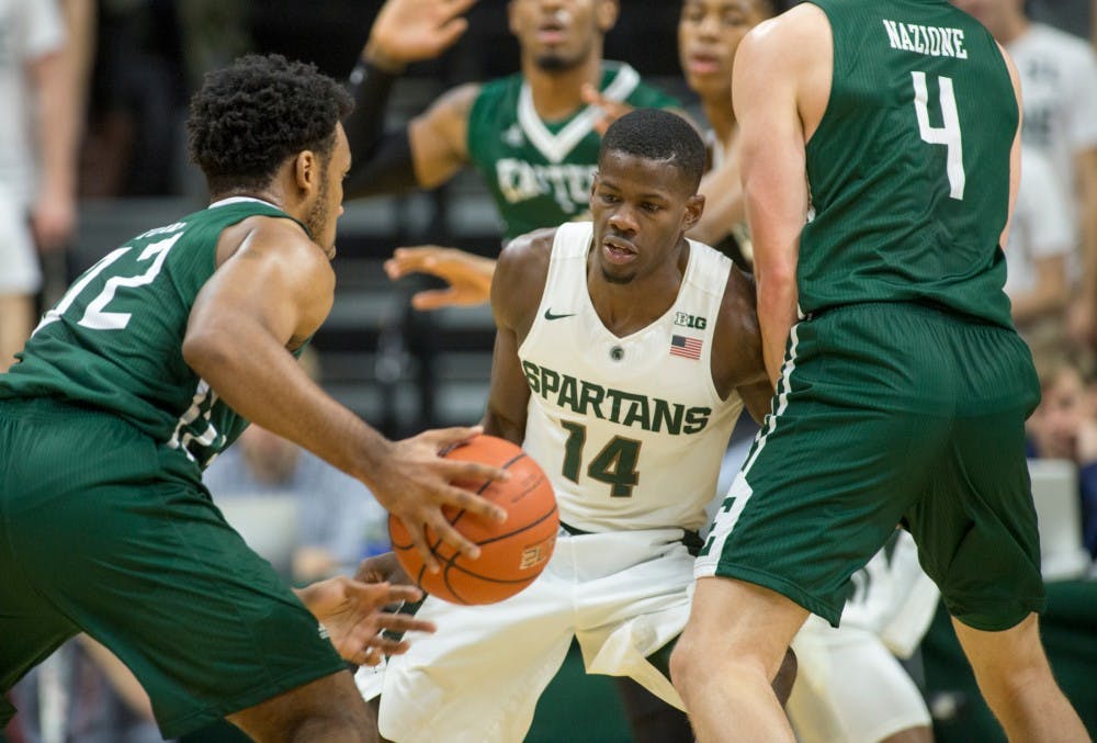 Junior guard Eron Harris defends against Eastern Michigan guard Daryl Kirkland during the first half of the game against Eastern Michigan on Nov. 23, 2015 at Breslin Center. The Spartans defeated the Eagles, 89-65.