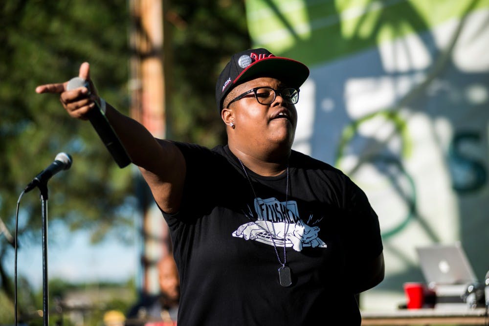 Lady Ace Boogie holds out her microphone to the crowd during Common Ground Music Festival on July 8, 2016 at Adado Riverfront Park in Lansing, Mich.