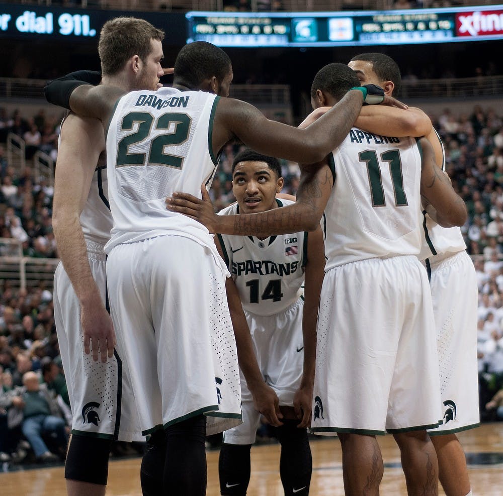 <p>Sophomore guard Gary Harris and teammates huddle up during a timeout March 1, 2014, at Breslin Center. The Spartans were defeated by Illinois, 53-46. Betsy Agosta/The State News</p>