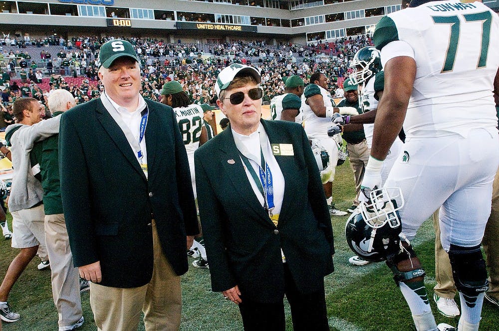 <p>MSU President Lou Anna K. Simon, center, stands between the celebrating Spartan players at the post game celebration Monday afternoon at the Outback Bowl hosted in Raymond James Stadium at Tampa, Fla. The last Spartan bowl game win was in 2000. Justin Wan/The State News</p>