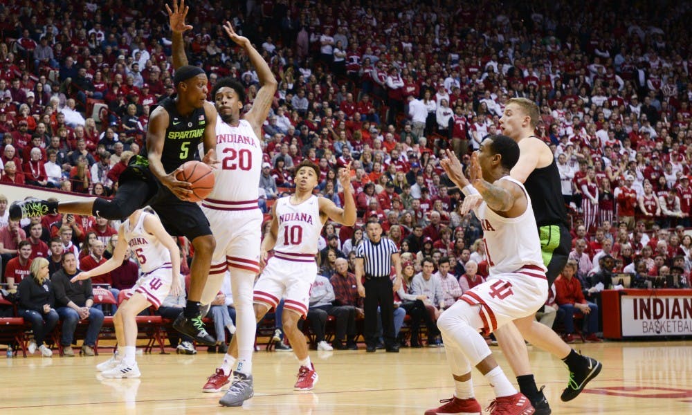 <p>Junior point guard Cassius Winston (5) jumps over players during the game against Indiana at the Bloomington Assembly Hall Mar. 2, 2019. The Spartans fell to the Hoosiers, 63-62.</p>