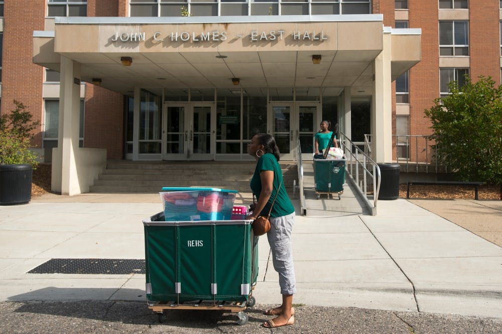 <p>Neuroscience and philosophy freshman Tamara Porter, center, waits for her parents Aug. 23, 2015, to help her move into her dorm in East Holmes Hall. Her niece Starr Alexander, 15, is in the background.</p>