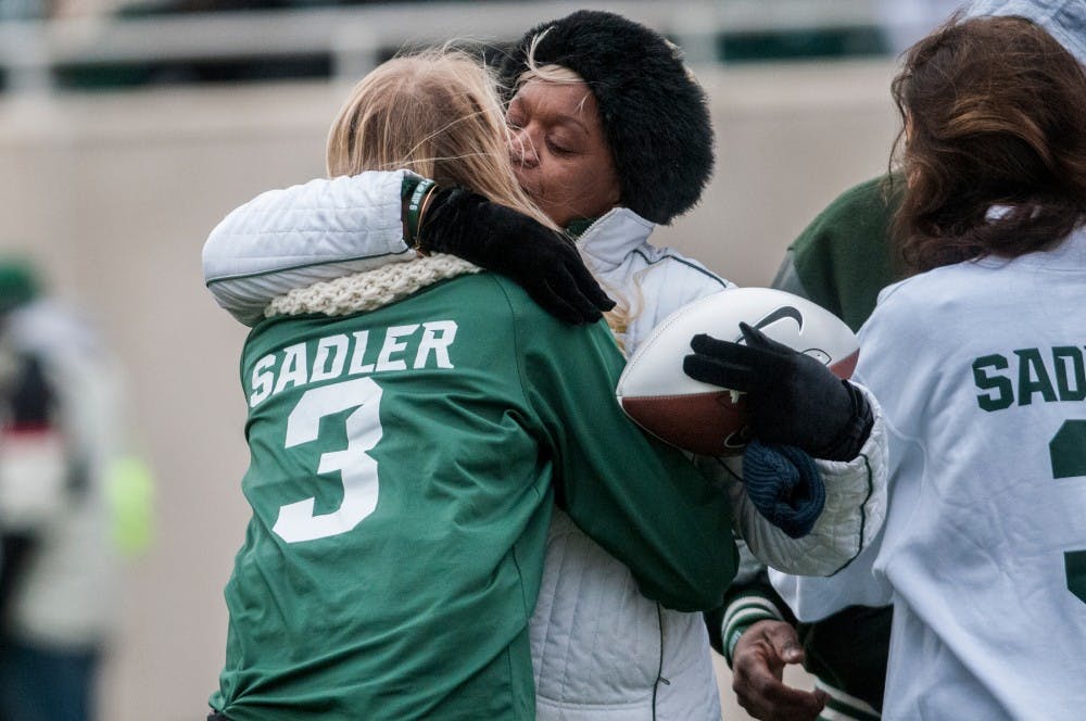 Family members of former punter Mike Sadler and former linebacker Mylan Hicks are recognized during a during the game against Ohio State on Nov. 19, 2016 at Spartan Stadium. Sadler and Hicks died unexpectedly a few months ago.