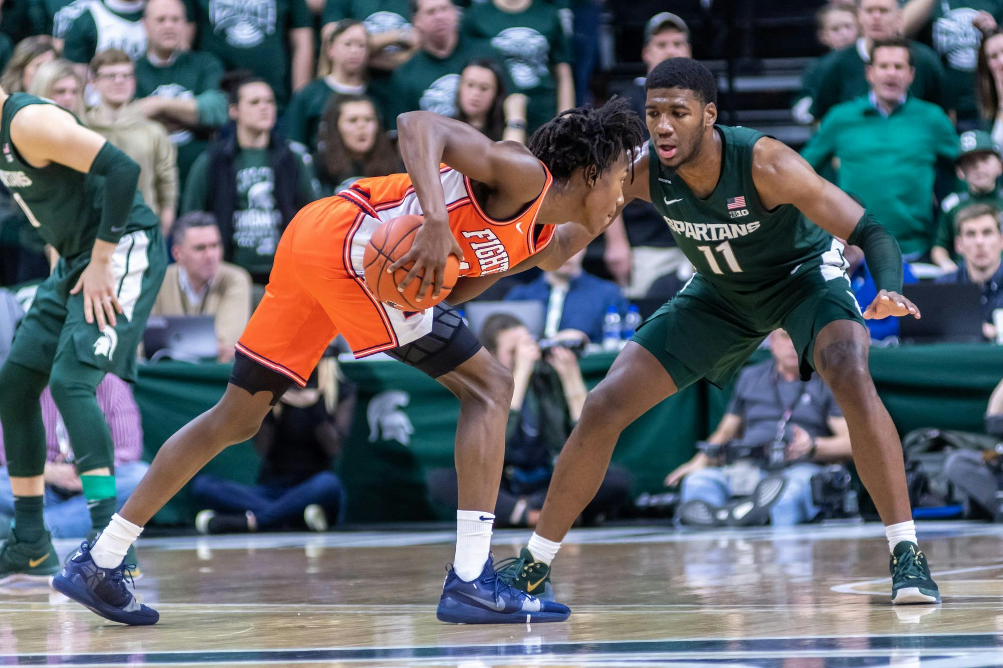 <p>Then-sophomore forward Aaron Henry (11) defends Illinois guard Ayo Dosunmu (left). The Spartans defeated the Illini, 76-56, at the Breslin Student Events Center on Jan. 2, 2020.</p>