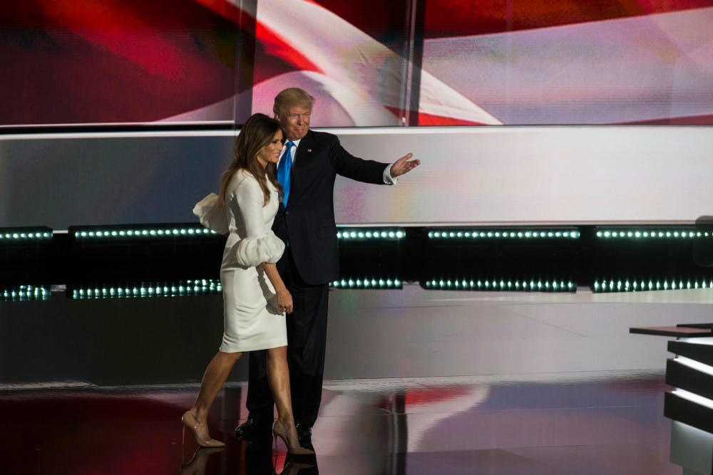 Presumptive nominee Donald J. Trump guides his wife Melania Trump toward the stage at the Republican National Convention on July 18, 2016 at Quicken Loans Arena in Cleveland, Ohio.
