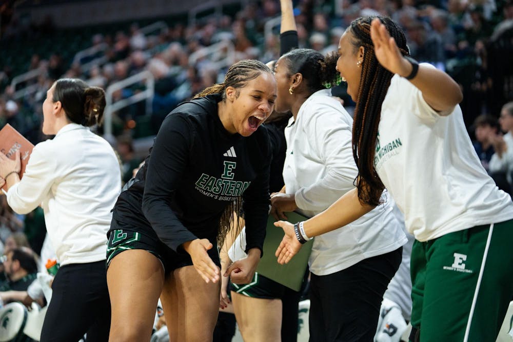 Eastern Michigan University players cheer on the sideline after a successful play during the game against Michigan State University at the Breslin Center on Nov. 11, 2024. The Spartans secured the win, 95-49, against the Eagles.