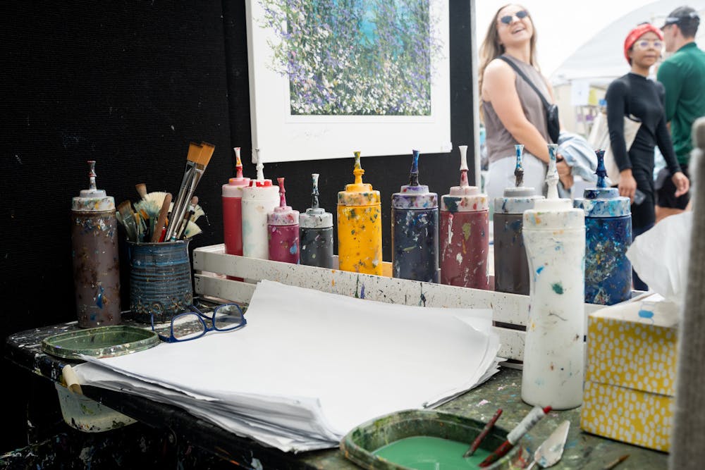 <p>A painter&#x27;s station waits for a brush during the East Lansing Art Festival on May 21, 2022.</p>