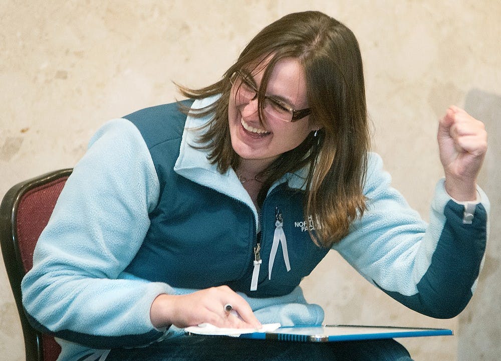 Mathematics junior Alyssa Rawling celebrates after receiving points for matching her answer with her roommate's at "The Roommate Game" held Oct. 26, 2012, at the Union. The game was similar to "The Newlywed Game" but involved roommates instead. Katie Stiefel/State News