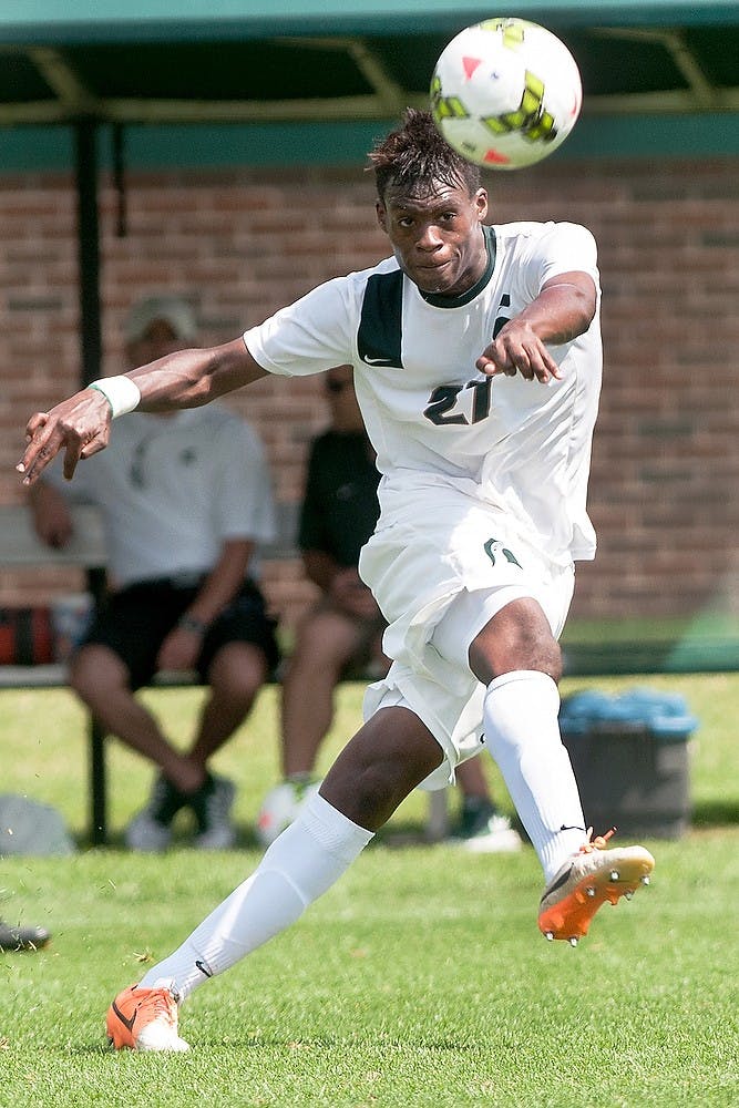 <p>Senior midfielder Fatai Alashe passes the ball during a game against Florida International University Aug. 31, 2014, at DeMartin Soccer Stadium at Old College Field. The Spartans defeated the Panthers, 3-0. Raymond Williams/The State News</p>