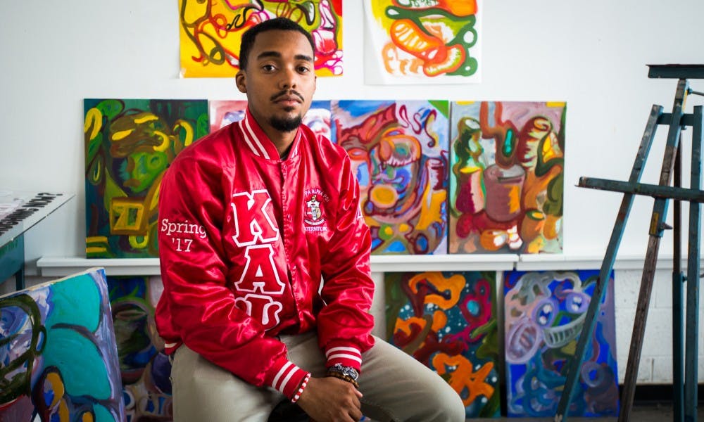 <p>Graphic design sophomore DeMarco Jackson poses for a photo on April 27, 2017 at Kergse Art Center. Jackson designs and sells his own apparel along with his own art.</p>