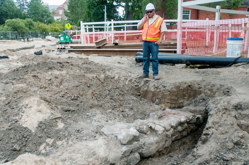 MSU Physical Plant Construction representative Andy Linebaugh observes the site of an early 1900's boiler room structure buried behind Morrill Hall Monday, July 9, 2012.  The MSU Archeology Department is currently inspecting the site. Adam Toolin/The State News