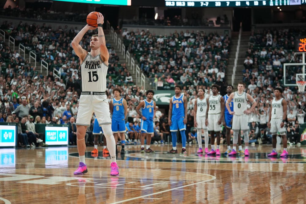 Michigan State senior center Carson Cooper (15) shoots a free throw against UCLA at the Breslin Center in East Lansing, Michigan, on Tuesday, Feb. 17, 2026.