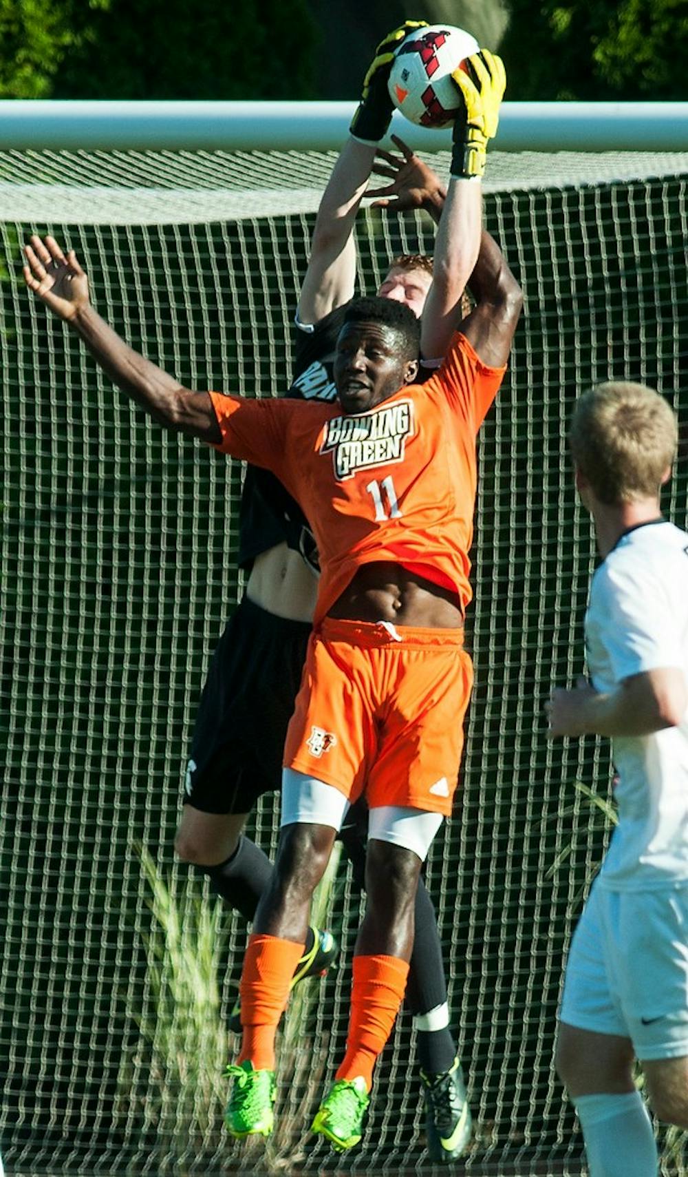 	<p>Sophomore goalkeeper Zach Bennett jumps up to make a save behind Bowling Green forward Anthony Grant during the game Sept. 18, 2013, at DeMartin Stadium at Old College Field. The Spartans defeated the Falcons, 1-0. Danyelle Morrow/The State News</p>