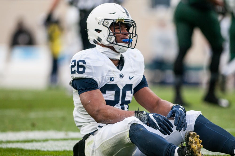 <p>Penn State running back Saquon Barkley (26) sits up after getting hit by a Spartan defender during the game against Penn State, on Nov. 4, 2017, at Spartan Stadium. The Spartans defeated the Nittany Lions, 27-24.</p>