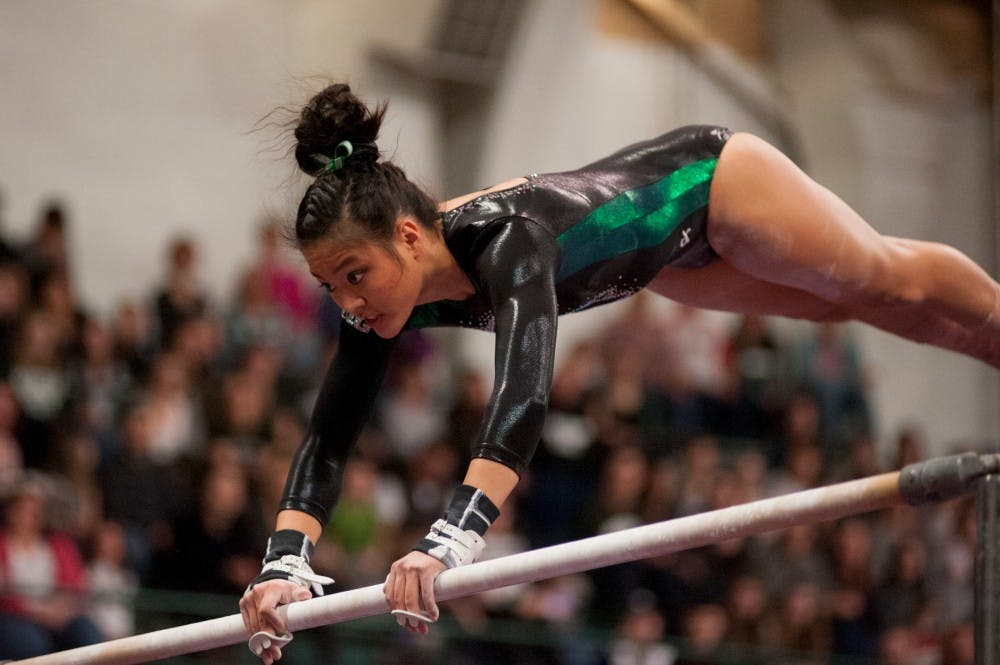 Sophomore Anna Gamelo preforms on the bars during the  MSU womens gymnastic's meet against Illinois on Feb. 19, 2016 at Jenison Field House.