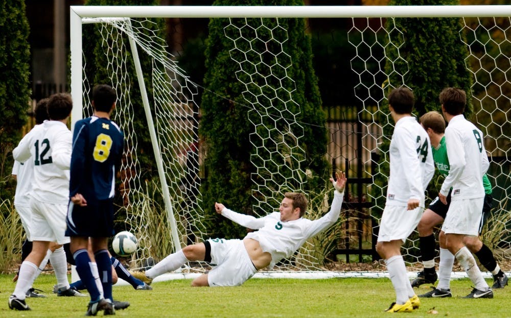 Then junior defenseman Colin Givens clears the ball away from the net preventing a goal against the Wolverines on Oct. 25, 2009 at DeMartin Stadium at Olde College Field. Givens, who was drafted by the Colorado Rapids, was a two-time All-Big Ten performer for the Spartans in three seasons. State News File Photo