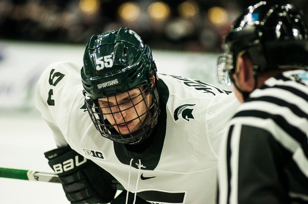 Sophomore forward Patrick Khodrenko (55) keeps his eyes on the puck during a faceoff during the game on Dec. 1, 2017 at Munn Ice Arena. The Spartans fell to the Fighting Irish 3-1. 