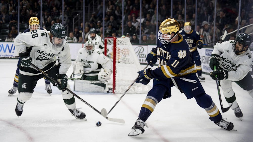 <p>Michigan State University junior forward Karsen Dorwart (28) takes control of the puck against Notre Dame at Munn Ice Arena on Nov. 16, 2024. MSU defeated Notre Dame 4-3.</p>