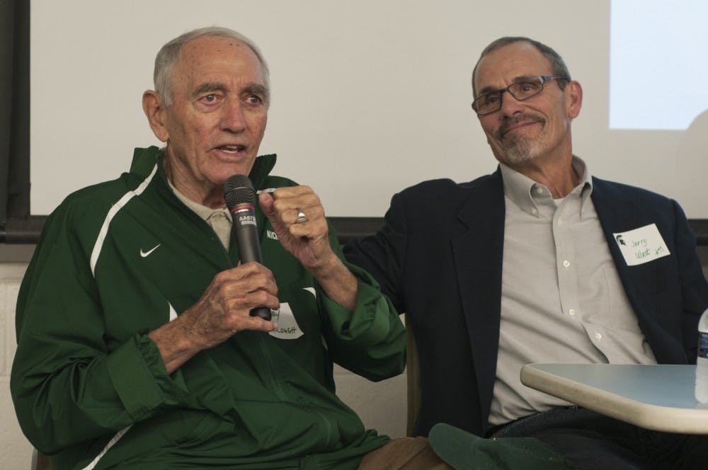 From left, former MSU coach Henry Bullough speaks into a microphone while former MSU player Jerry West listens on Oct. 12, 2016 in Conrad Hall. Bullough coached and West played on the MSU football teamd during their 1966 game against Notre Dame.